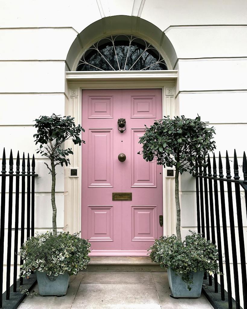 Pink entrance door in old building